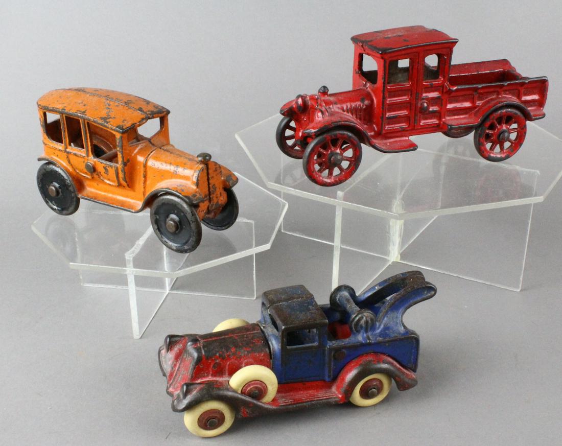 Cast Iron Car & Trucks: Cast Iron Car & Trucks. Hubley Take apart wrecker, stake truck, and Dent sedan.