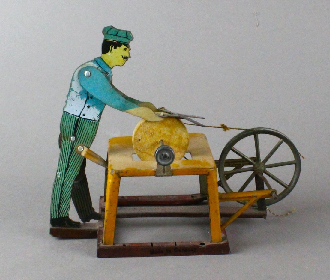 Bing German Tin Scissor Sharpener Man: Bing German Tin Scissor Sharpener Man at stone. German tin steam toy.