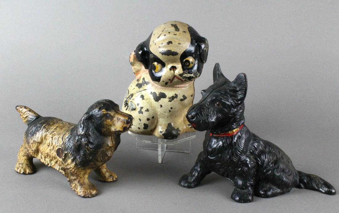 Hubley Dog Still Bank & 2 Dogs: Hubley puppy still bank, Scottish Terrier, and Springer Spaniel cast iron dogs.