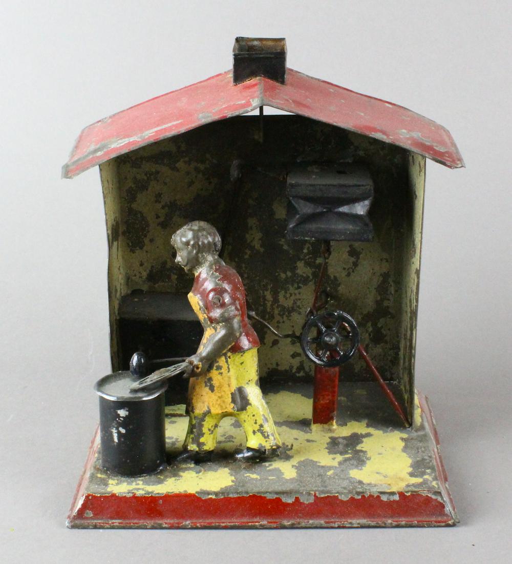 German Tin Blacksmith at Forge: German Tin Blacksmith at Forge. Probably Bing or early Arnold, wear adds a very period feel to the dirty hard work of the forge.