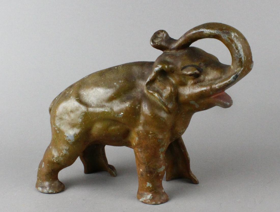Cast Iron Elephant Doorstop Trunk Up: Cast Iron Elephant Doorstop. Elephant is trumpeting with trunk. Fine original paint 10 inches long.