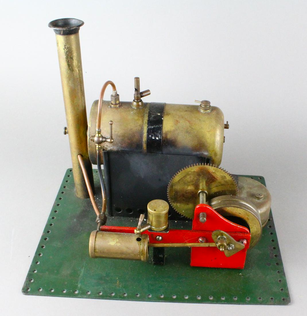 Bowman Gear Flywheel Steam Engine: Large Bowman Gear Flywheel Steam Engine brass and steel mounted on Meccano base. Powerful plant with large piston and flywheel, speed control lever. 11 x 9 x 9 height.