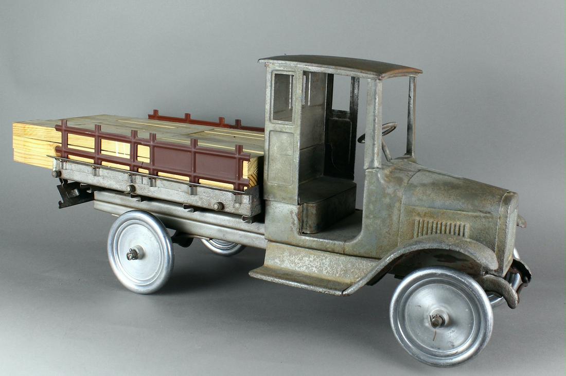 Buddy L Hauling Truck: Buddy L Hauling Truck used as stake truck for timber. Excellent shape ready for painting! 26 inches long.