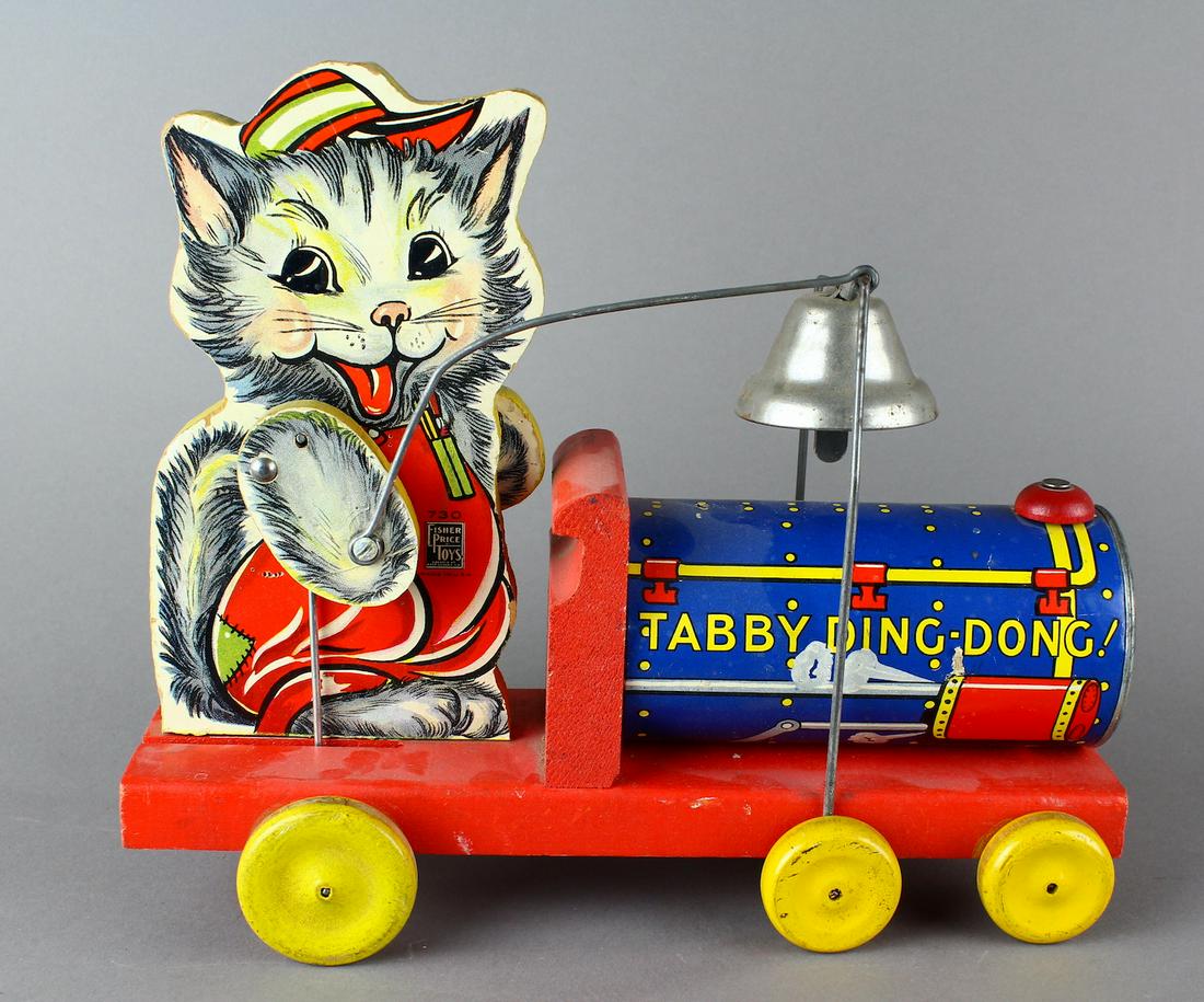 Fisher-Price No. 730 Tabby Ding Dong Toy: American. Paper on wood. Excellent condition. Cat\'s articulated right arm rings bell when toy is in motion. 11 inches long.