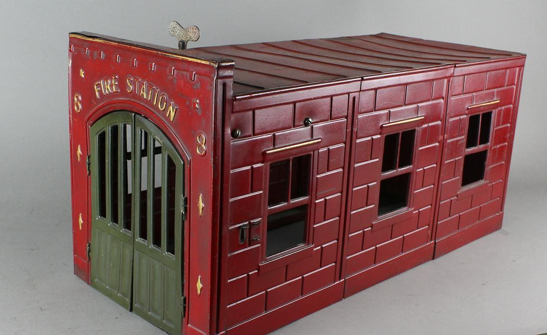 Kingsbury Fire Station 8 Firehouse: Kingsbury Fire Station 8 Firehouse- Pressed steel, red building with green bay doors, mechanical action, rings bell and opens door to release fire truck. 19 1/2 inches deep. (Needs adjustment to run).