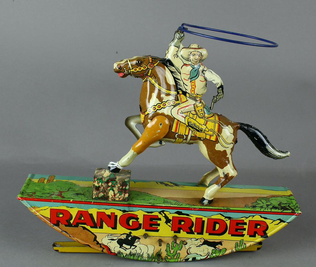 Marx Range Rider Wind Up Cowboy: Marx Tin Range Rider Wind Up depicts cowboy with lasso on rocker base, clockwork driven. 11 1/2 inches long.