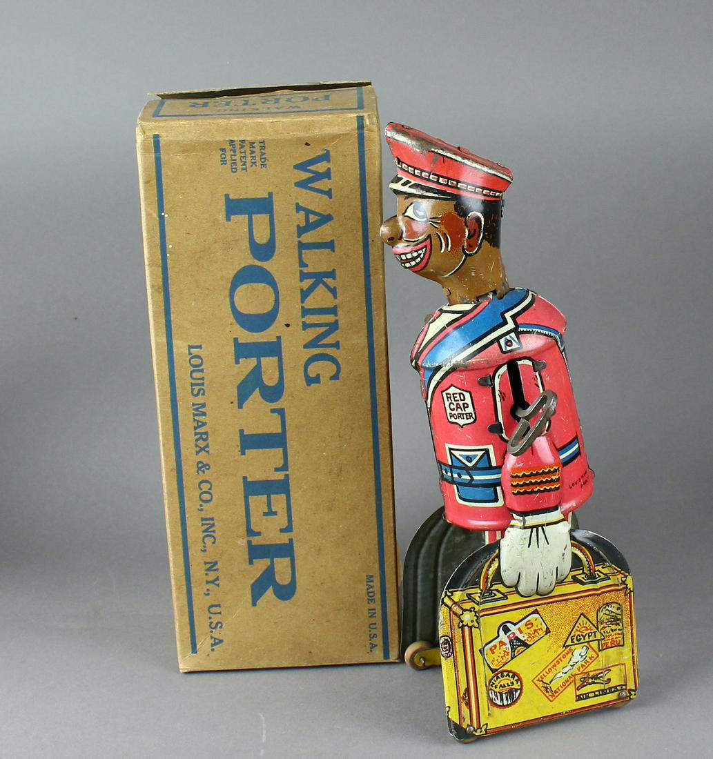 1930s Marx Red Cap Porter in Box: 1930s Louis Marx Tin Red Cap Porter Wind Up Toy Black Train Porter Luggage Man in the original box. Fine working clockwork driven wind up toy measures 8 1/2 inches tall. From a historical period of ti
