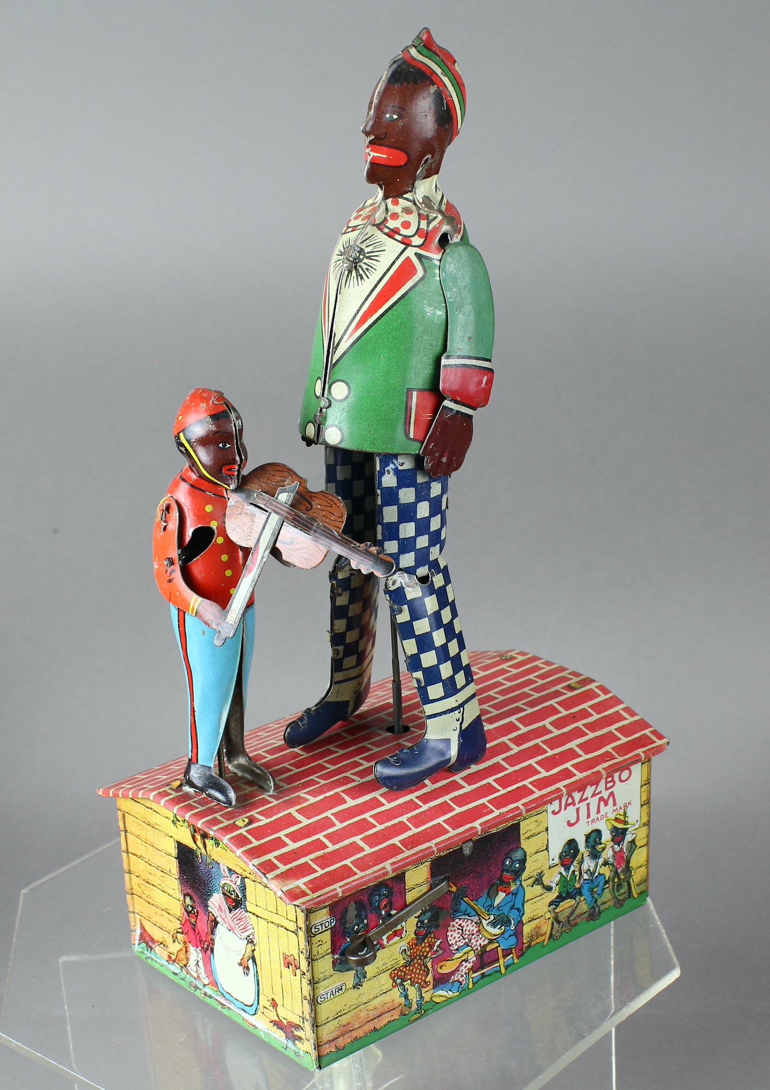 1921 Jazzbo Jim Dancer on Roof w Violin Player: 1920s Unique Art Jazzbo Jim Dancer on Roof w Violin Player. Tin toy wind up with fiddle player and jigger dancer. Excellent working wind up toy. 9 inches tall.