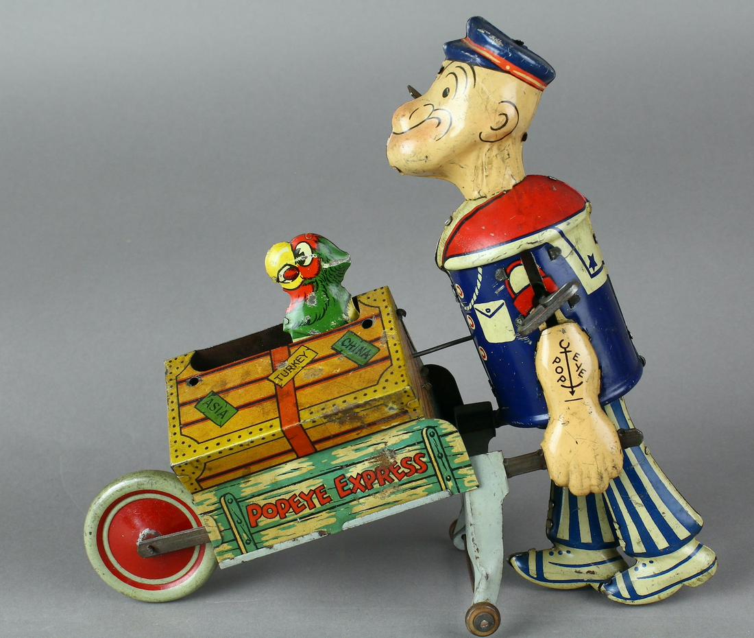 1930 Marx Popeye Express with Pop out Parrot: Marx Tin Popeye Express with Pop out Parrot. Wind-up toy, parrot pops up from trunk as Popeye walks along pushing his trunk. Nice bright litho. 9 inches long.