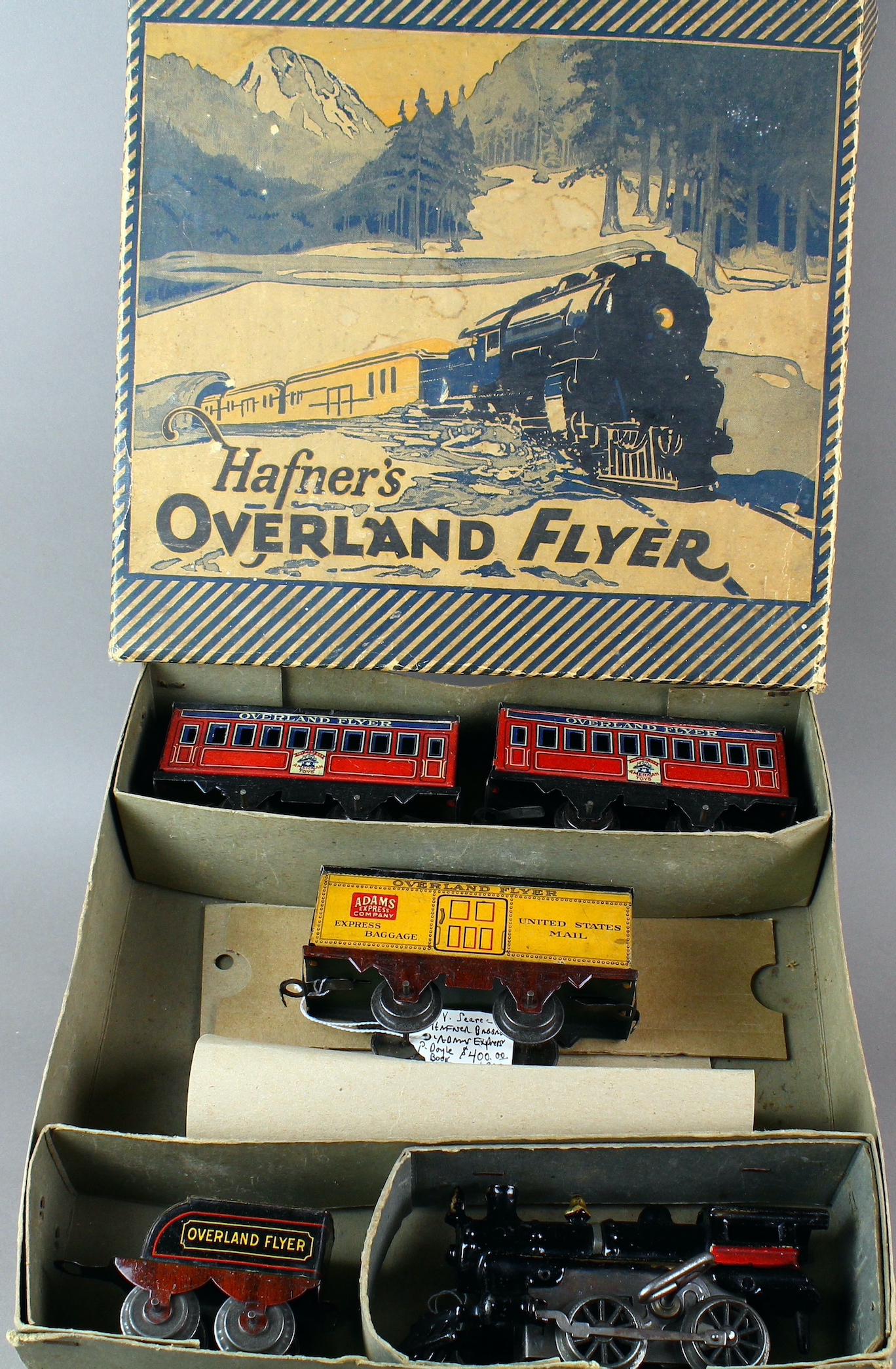 Hafner Overland Flyer Train Set in Box: Hafner Overland Flyer Train Set in Box. Excellent working cast iron clockwork engine, 3 cars- mail and passenger and original box. (Track not in box, but can provide some track if needed).