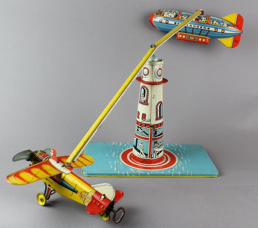 Unique Art Sky Rangers Zeppelin & Airplane: Unique Art Sky Rangers Zeppelin & Airplane. Original working wind up tin toy. Original balance bar may need adjustment or a piece of metal coat hanger to straighten but toy works fine. 27 inch span, 9