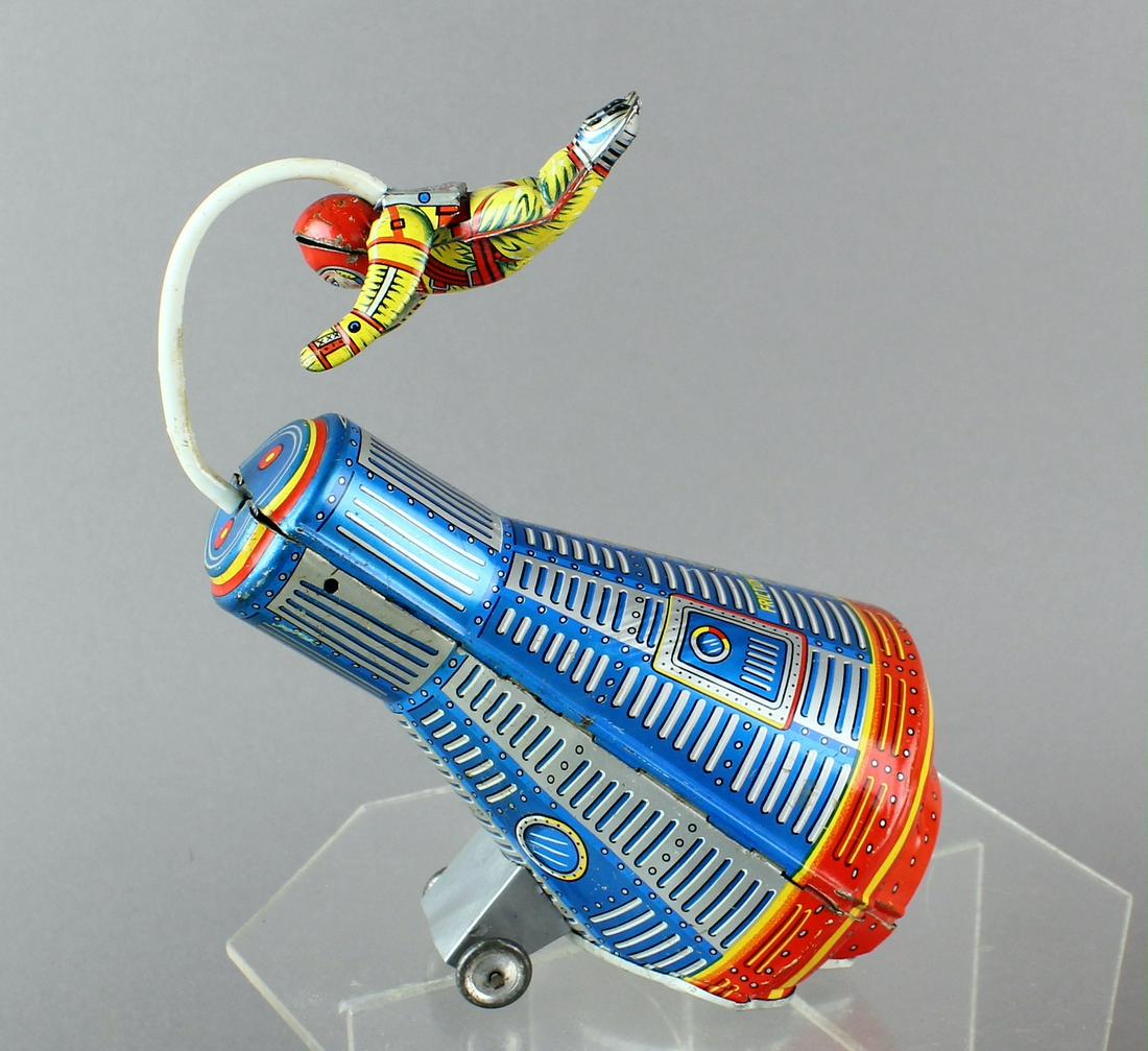 Japan Tin Space Capsule & Floating Astronaut: Kanto Japan Tin Space Capsule & Floating Astronaut friction toy. As wheels turn the astronaut does a space walk around the capsule. Hard to find toy. Working, some wear, 7- 8 inches across.