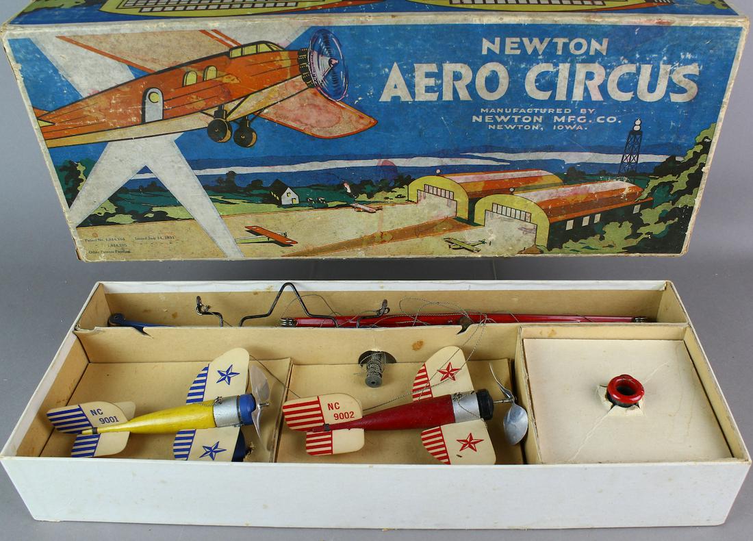 Newton Iowa Aero Circus & Zeppelin In Box- Pristine: Newton Iowa Aero Circus & Zeppelin In Box. Newton Mfg. Newton Iowa, Aero Circus Airplane Toy in Box. Complete with cast iron Zeppelin base. Pristine crisp set with all the parts, and complete box. Bea