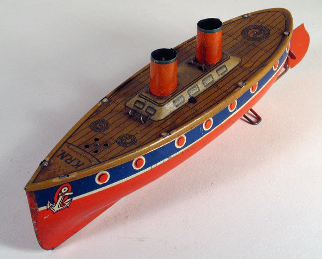 KRN German TIn Ship 1920s Rare Boat: KRN (KARL ROSENBAUER) German tin ship, with working clockwork, propeller, rudder and built in stand, pre-war circa 1920. Rare toy by the little known Rosenberger firm of Nuremberg, Germany. Length 8 i