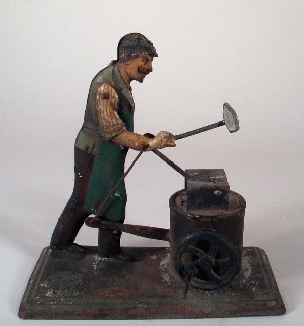 BING Blacksmith Mechanical Handcrank/Steam Toy: BING German tin blacksmith, mechanical handcrank toy, pre-war circa 1920s. Detailed and attractive toy, with realistic litho of working blacksmith. As crank is turned, hammer hits anvil. Good conditio