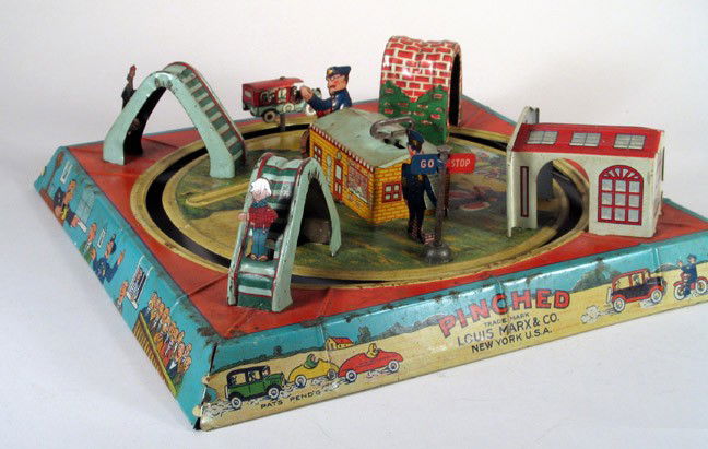 MARX "Pinched" Car Chase Police Motorcycle Toy: MARX "Pinched" diorama track toy, with working clockwork, pre-war circa 1930. Desirable and attractive tin Marx toy, with detailed litho. Speeding car attracts the attention of the hiding motorcycle c