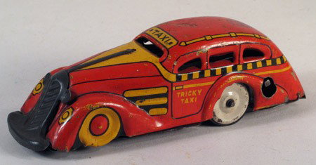 MARX Tricky Taxi Cab Red & Yellow 1930s: MARX Tricky Taxi, with working clockwork, pre-war circa 1920-1930. Interesting mechanical action, when wound, car travels forward and turns at end of surface. Length approx. 3.5 inches. Marx manufactu