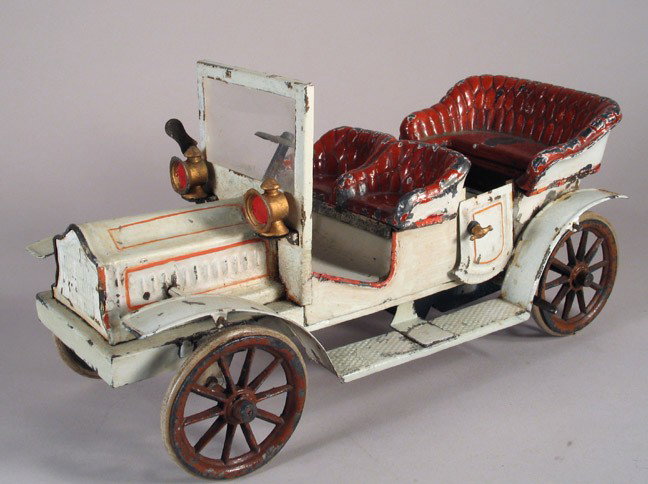 BING or CARETTE Open Touring Car Early 1910 WU: BING or CARETTE German tin open touring car, pre-war circa 1910. Special, very early auto with simulated fabric seats, running boards, steering wheel, opening rear doors with handles, rubber tires. La