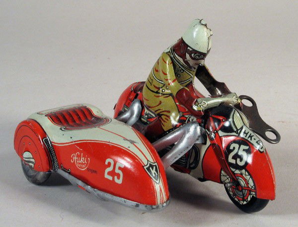 HUKI (KIENBERGER) Motorcycle & Sidecar w/Driver: HUKI (KIENBERGER) German tin motorcycle with sidecar No. 25, working clockwork, post-war circa 1950-1955. Very attractive small German cycle with key. Detailed litho on figure, motorcycle and sidecar.