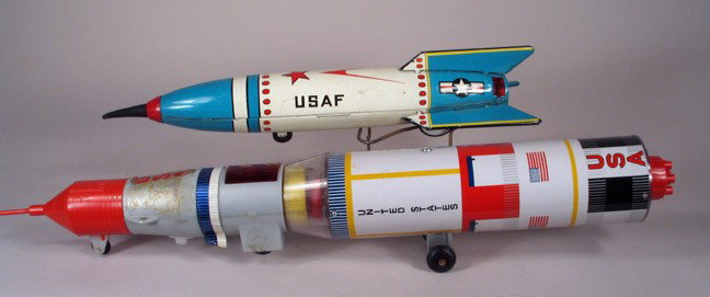 JAPAN: Pair Rockets USAF & Apollo Rocket: JAPAN LOT: 2 USA rockets. USAF rocket c.1950s is 14 inches long friction/sparking toy (needs flint). Multi-stage Apollo rocket c1968 is tin and plastic and over 18 inches long. Apollo is working batte