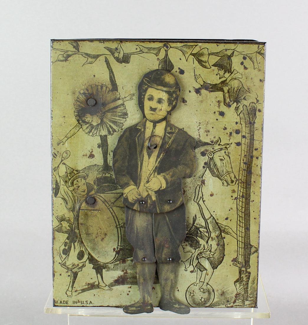 1920s Charlie Chaplin Tin Dancer On Stage B&R: Tin windup attributed to B&R with unmistakable image of Charlie Chaplin. Chaplin dances in front of stage background with circus performers and animals. 7 inches tall working, excellent litho.