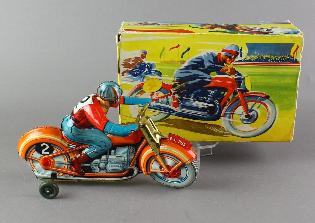 Technofix German Tin Motorcycle in Box: Technofix German Motorcycle racer wind up in Box. Bright clean excellent motorcyle and nice graphic box. Box missing one side flap. Working wind up when tested.