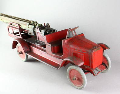 1920's Buddy L Toy Pressed Steel Aerial Extension Ladder Fire Truck: 1920's Buddy L Toy Pressed Steel Aerial Extension Ladder Fire Truck. Brass bell, crank-operated extension ladders in working condition, original red paint with "CFD" decals on each truck door, additio