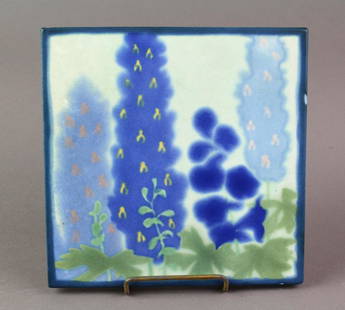 Marblehead Tile: Marblehead art pottery tile decorated with delphiniums on yellow ground with blue border. 5 3/4 inches. No chips or cracks.