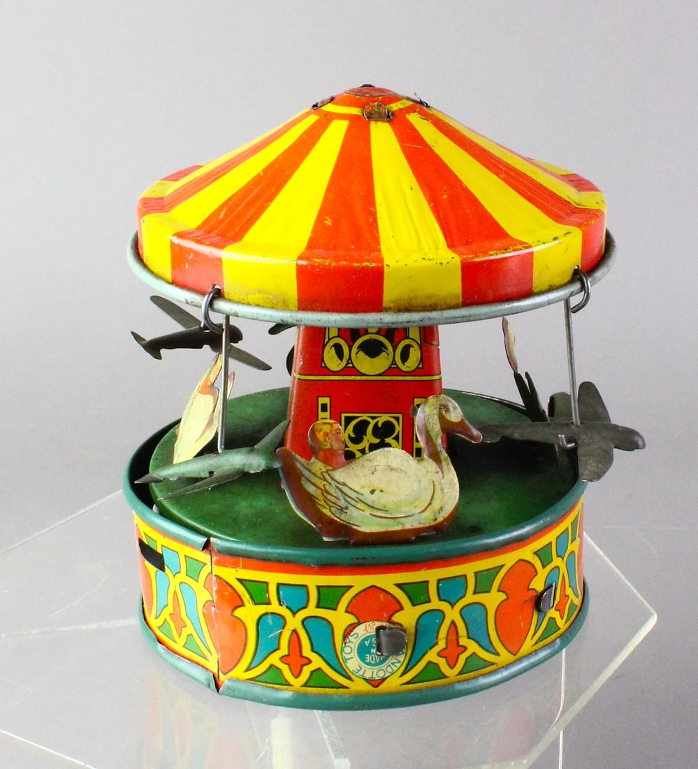 1930s Wyandotte Tin Airplane & Swans Carousel: 1930s Wyandotte Tin Airplane & Swans Carousel. Push rod runs very short duration 5 inches wide.