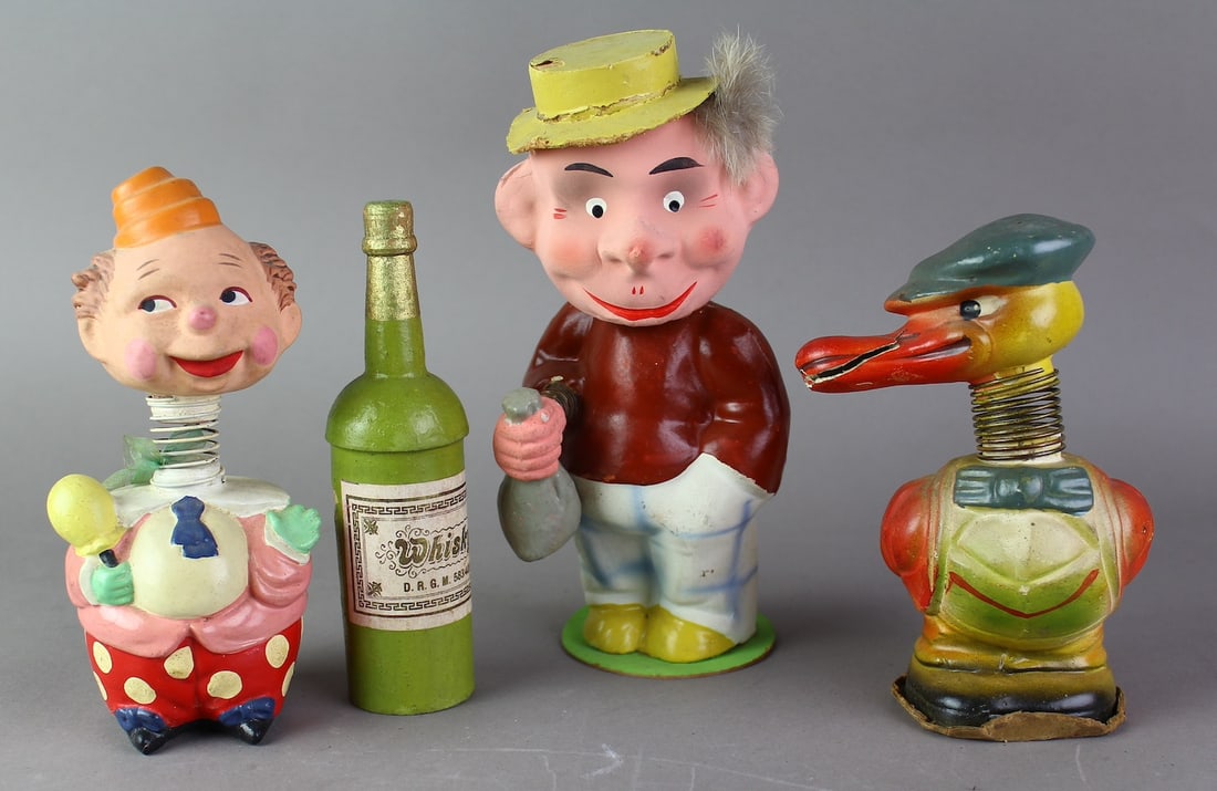 German Composition Nodders: 3 German Composition Nodders and composition whiskey bottle. Tallest 7 3/4 inches.