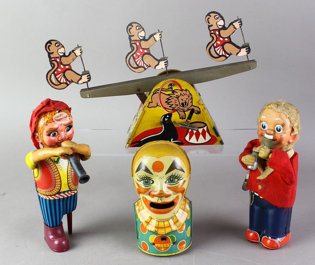 Japan & US Wind up Tin Toys & Chein Bank: Japan wind up Peg Leg Pete & Drinker working wind ups. J. Chein Clown bank- tongue goes out for coins. Lewco Circus Monkey see-saw wind up. Widest 9 1/2 inches.