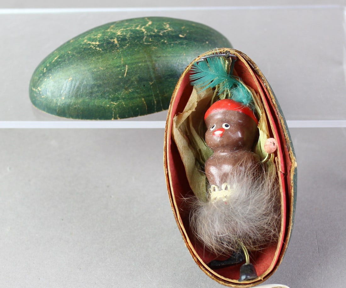 Rare Austrian Watermelon with Black Memorabilia Figure: Austrian painted paper/composition watermelon which opens to reveal composition native figure. Original excellent condition rare Jim Crow era souvenir toy. 4 inches long. Appears to be German but ther