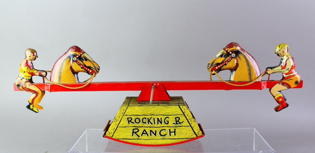 Courtland Tin Wind Rolling R Ranch Cowboy See-Saw: Courtland Tin Wind Rolling R Ranch Cowboy See-Saw. Working bright litho tin toy. 18 inches wide.