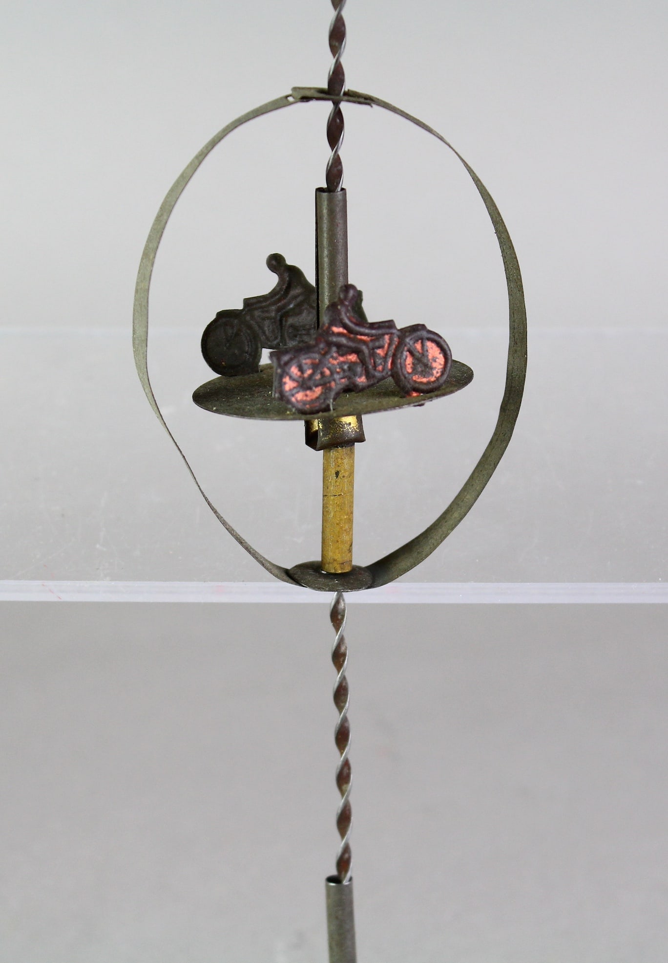 1920 German Tin Motorcycle Spinner Toy: 1920 German Tin Motorcycle Spinner Toy. 2 Motorcycles spin around as they go down the toy pole. About 12 inches. Rare penny toy.