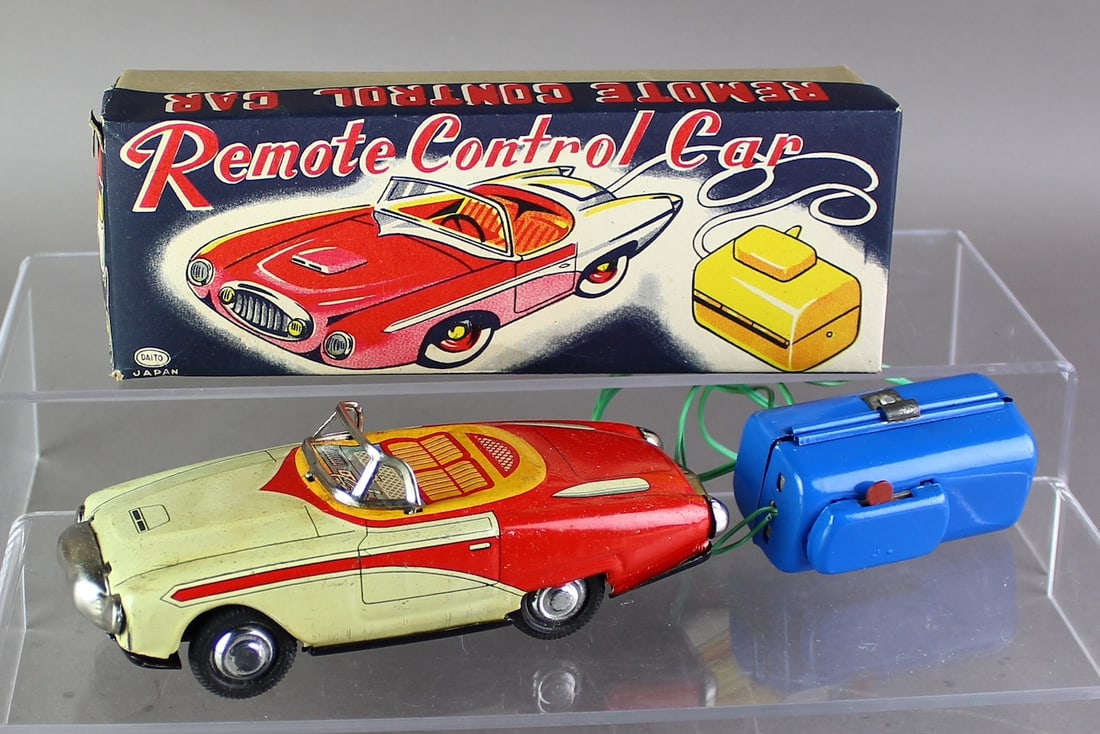 1950s Japan Daito Remote Controlled Car in Box: Japan Daito Remote Controlled Car in box. Tin Corvette style concept car working tin car with remote battery operated control in the original box. Car goes in forward and reverse, 6 1/4 inches.