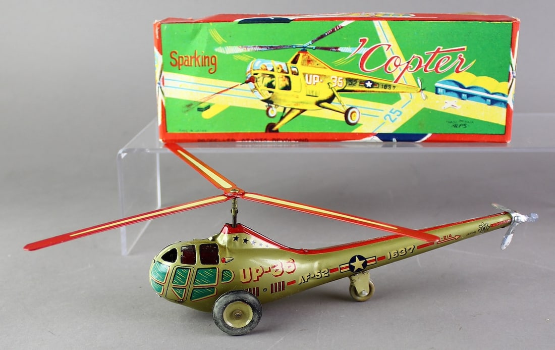Alps Japan Tin Sparking Copter Helicopter in Box: Alps Japan Tin Sparking Copter Helicopter in Box. Near mint Friction helicopter 7 1/2 inches long in bright box.