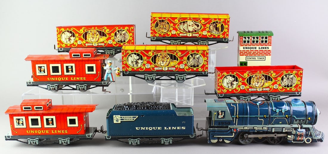 Unique Lines Tin Trains & Circus Cars & Animated Caboose: 1950 Tin Toy Unique Art Locomotive and Tender and colorful Jewel T circus freight and animal cars & rail building. 2 Cabooses one with Benny the Brakeman. Strong lithography.