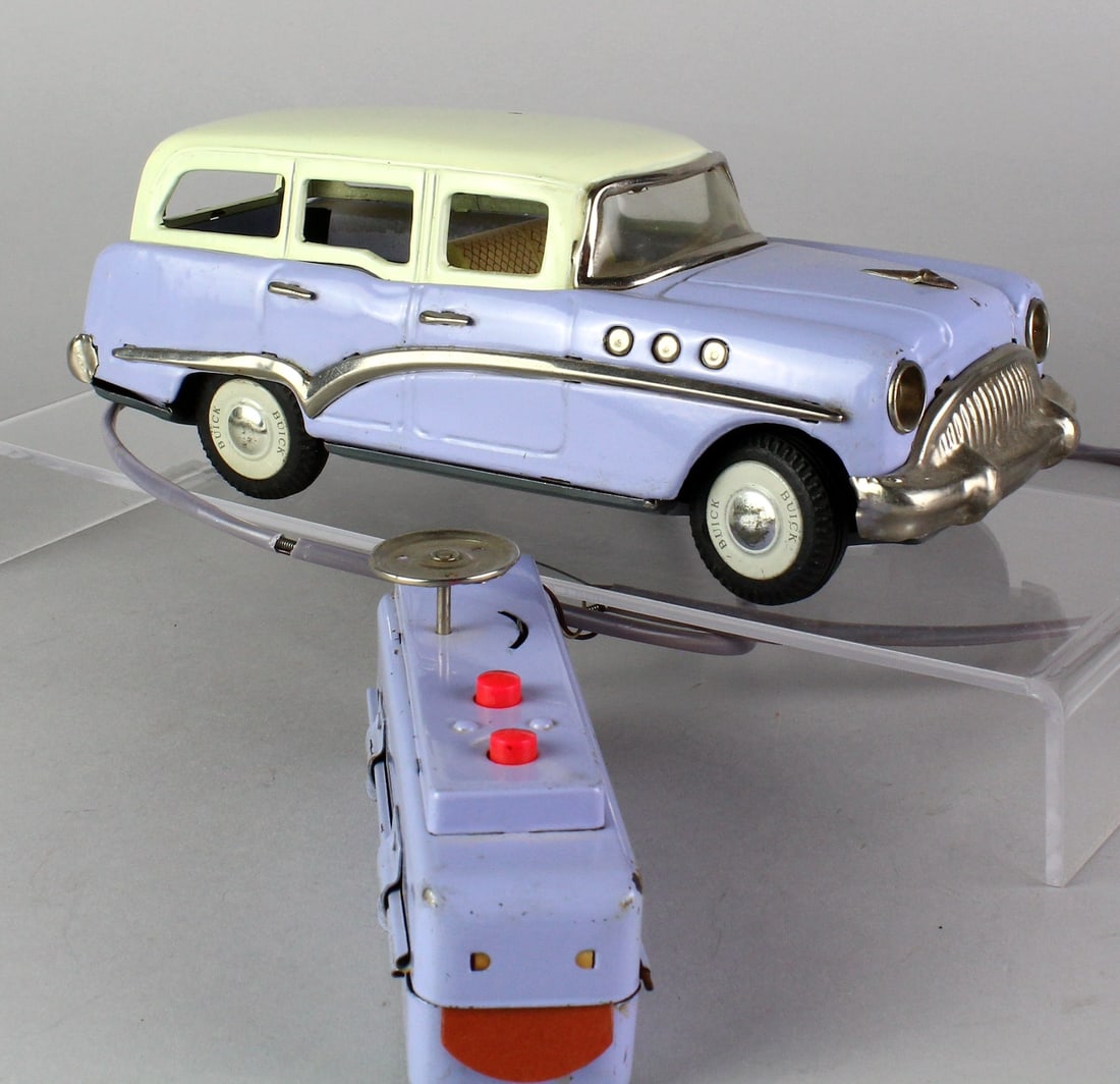 Japan Tin Lavender Buick with Remote: Japan Tin Lavender Buick with Remote. Scarce battery operated Buick and remote in excellent condition. Station wagon is 9 inches long. Remote not working.