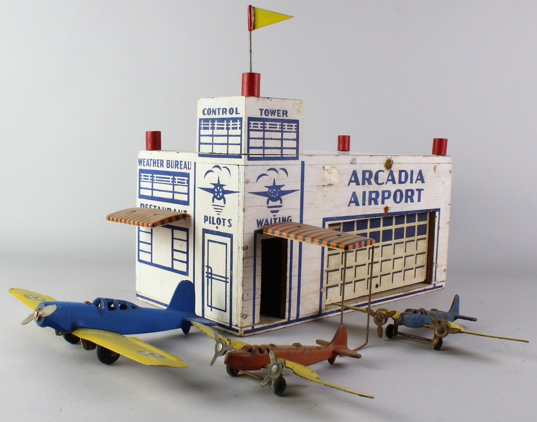 Arcade Arcadia Airport & Airplanes: Arcade Arcadia Airport Building & 3 Airplanes. Arcade airport retains the awnings, flag and garage door 13 inches wide. Arcade monoplane with a 10 inch wingspan. Pair of double propeller airplanes wit