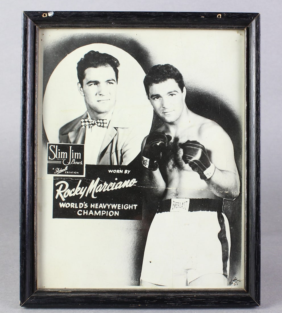 1950s Rocky Marciano Promo Ad Photo for Bow Ties!: Unusual original advertising photo of famous boxer Rocky Marciano advertising Slim Jim Bow Ties! The Heavyweight champion is seen in the background in a reluctant pose with a bow tie and jacket.