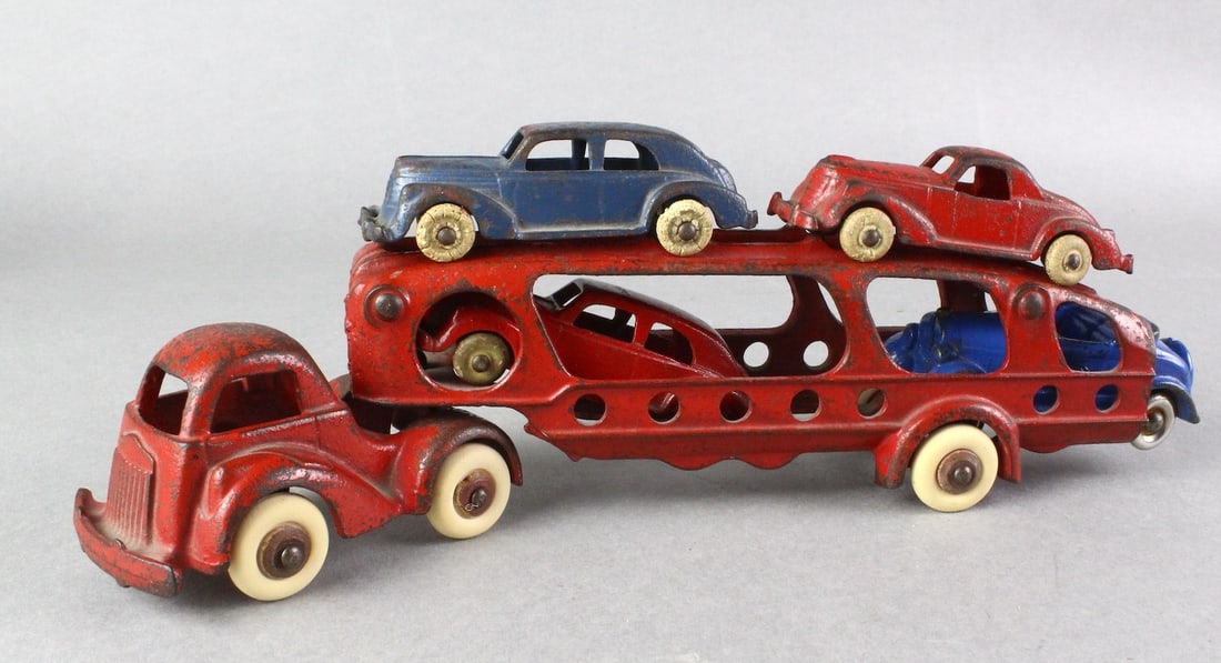 1939 Hubley Auto Hauler & 4 Cars: Hubley Cast Iron Auto Hauler with 4 cars, 10 inches long, one is a Kilgore roadster, blue car tire included (not in photo).
