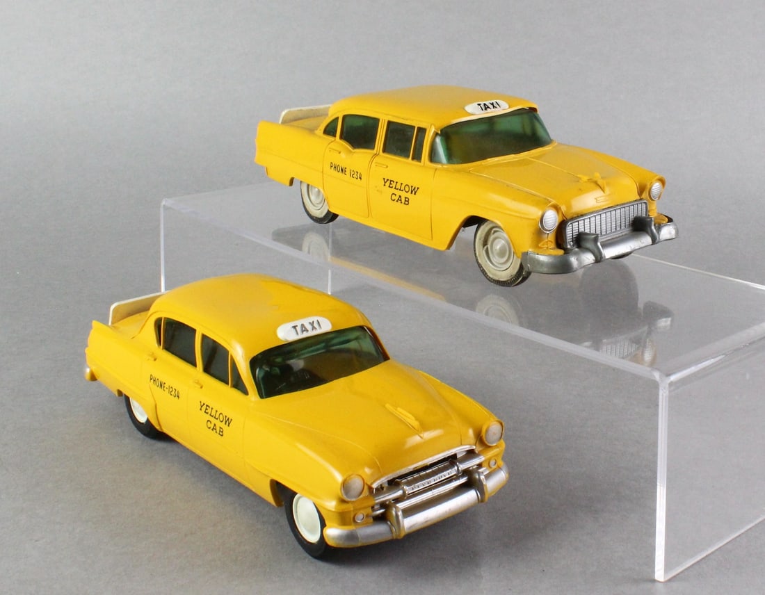1954 & 1956 Plymouth & Pontiac Taxi Cab Promo Cars: PMC 1954 Plymouth Yellow Cab Taxi Promo, 1956 Pontiac Taxi Dealer Promo with the original whitewall tires. Both cars sporting the Tru-Miniatures safety signs. Scarce.