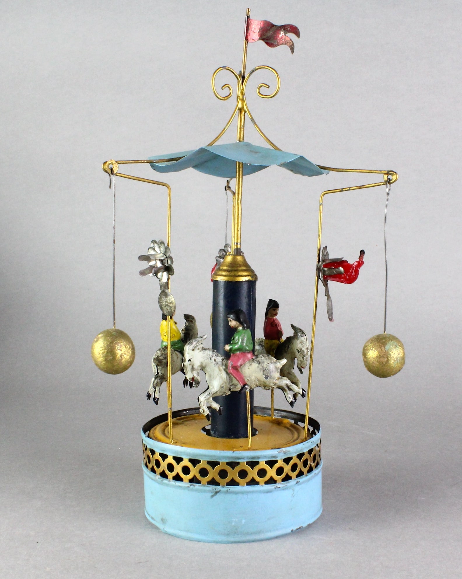 German Tin Carousel with Goat Riders: German Tin Carousel Riders on Goats. Has fixture for small candles. Carousel wind up works, 13 inches tall.