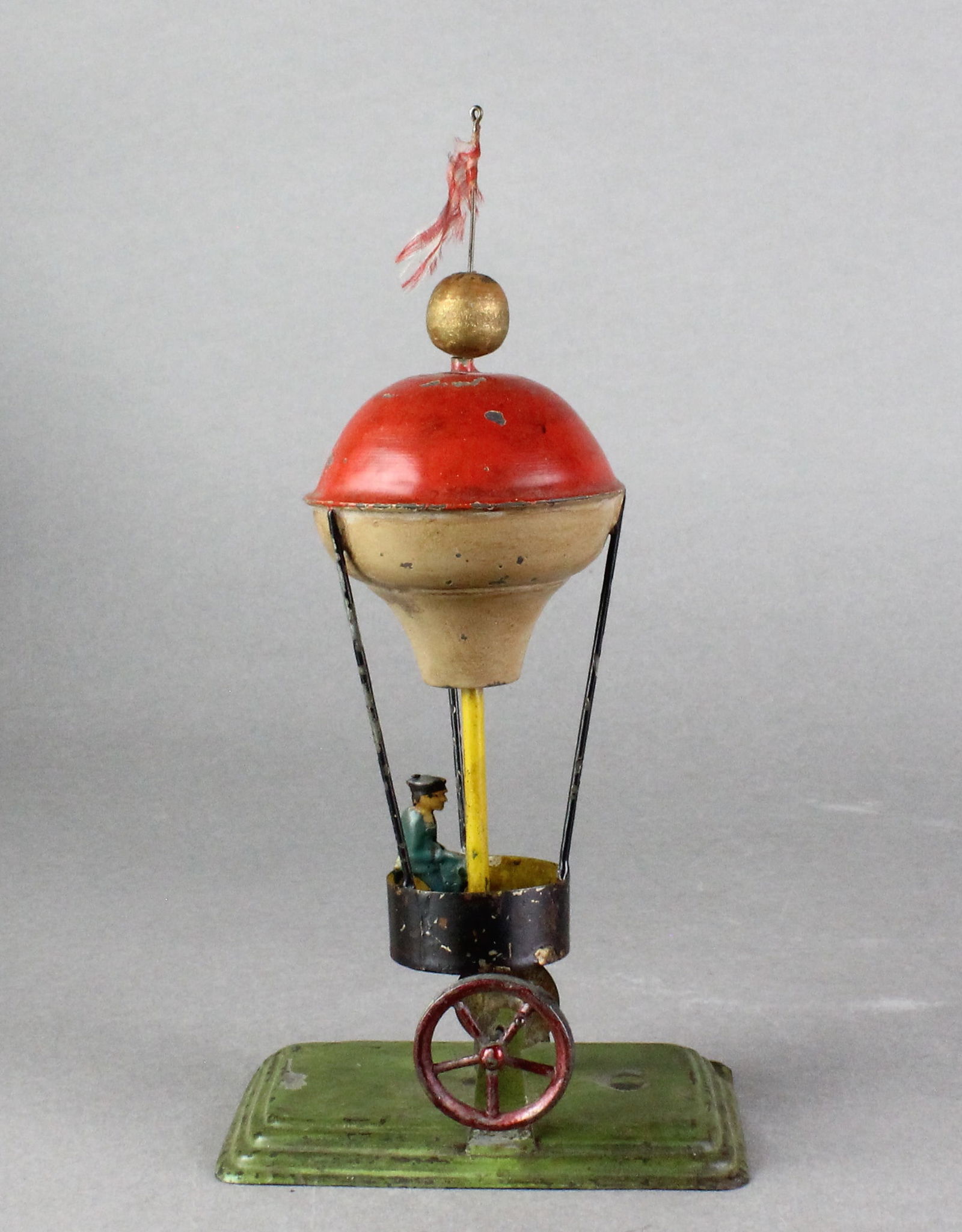 1900s German Hot Air Balloon Tin Toy: German Hot Air Balloon Tin Toy. Scarce steam/crank toy, balloon turns. 8 1/2 inches tall.