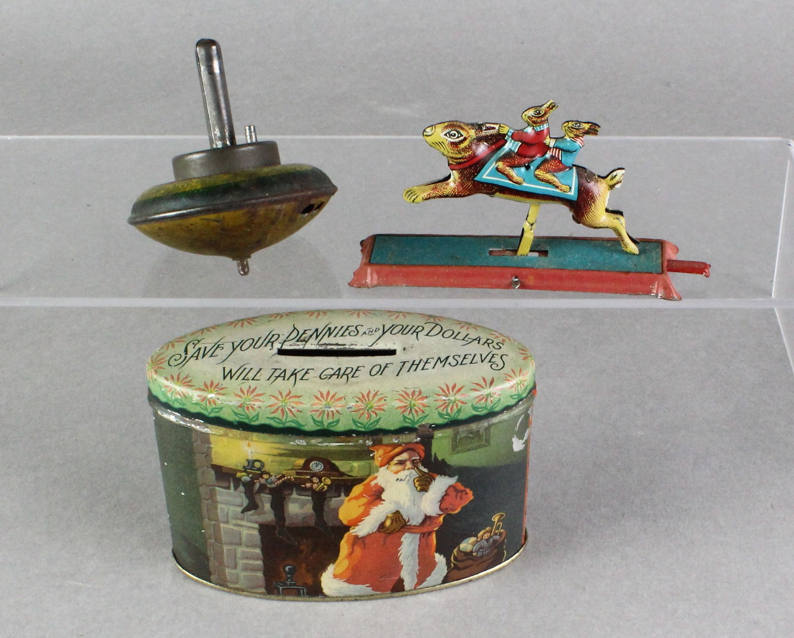 Tin Santa Bank & Tin Toys: Tin Santa Bank - "Save Your Pennies, Your Dollars Will Take Care Of Themselves", 4 inches long. Tin Rabbit ride penny toy and Tin spinning top.