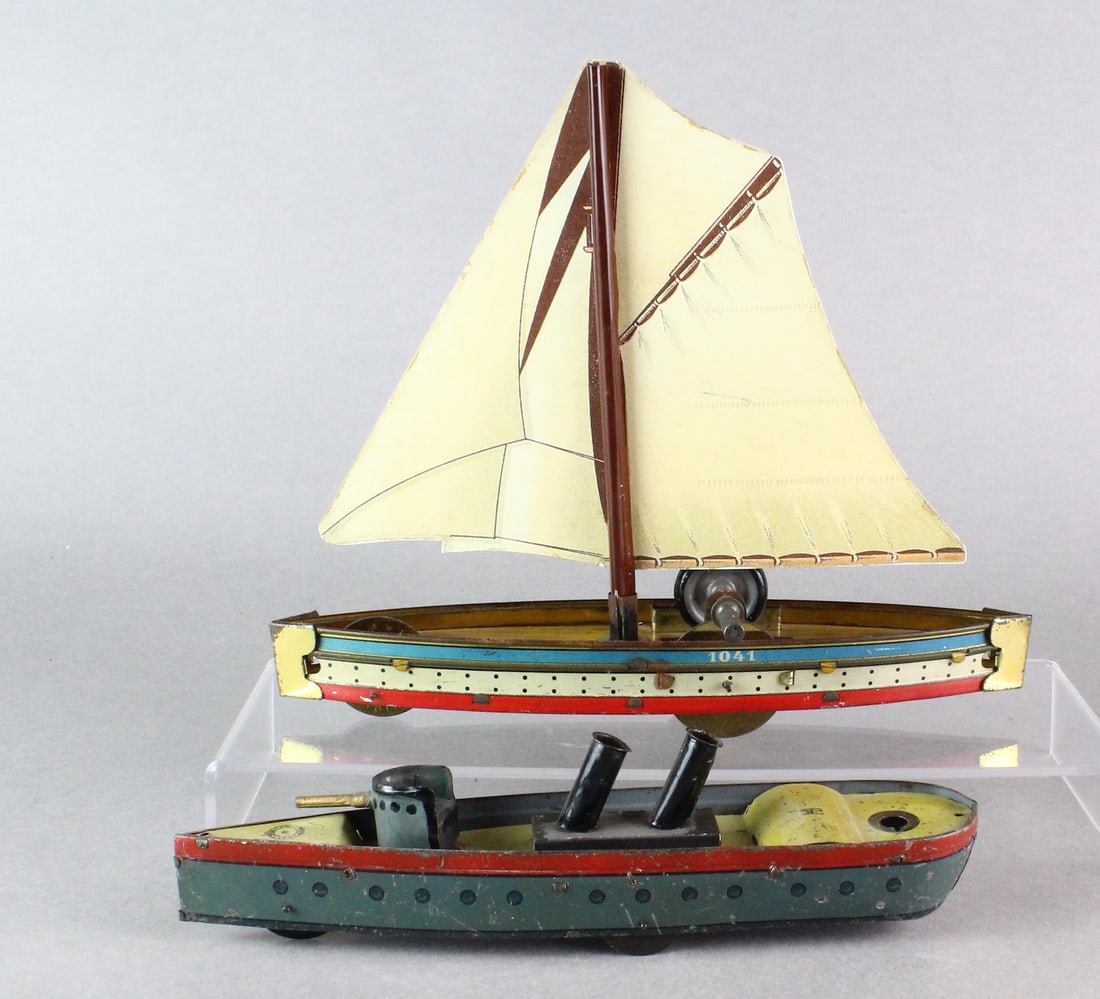Hess German Tin Sailboat & Battleship: Hess German Tin Sailboat & Battleship. Longest 10 inches. Well done replacement sail, missing piece on battleship.