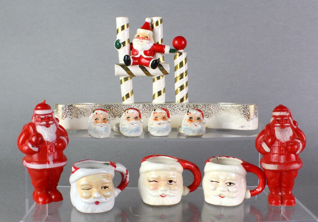 1950s Santa Group Holt Howard, Japan, Hard Plastic: 1950s Santa Group. Holt Howard centerpiece candle display 10 inches wide, Japan Miniature Santa Mugs (one damaged), Santa Napkin Rings (one extra damaged) 2 Hard Plastic Santa Claus with Bag figures.