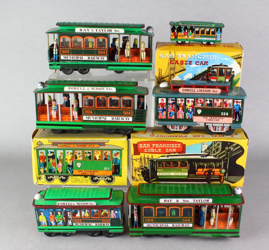 Japan Tin San Francisco Cable Cars & Boxes: Six Japan tin Cable Cars with 3 in the box. Tin original friction cable cars with bells, longest 7 1/2 inches.