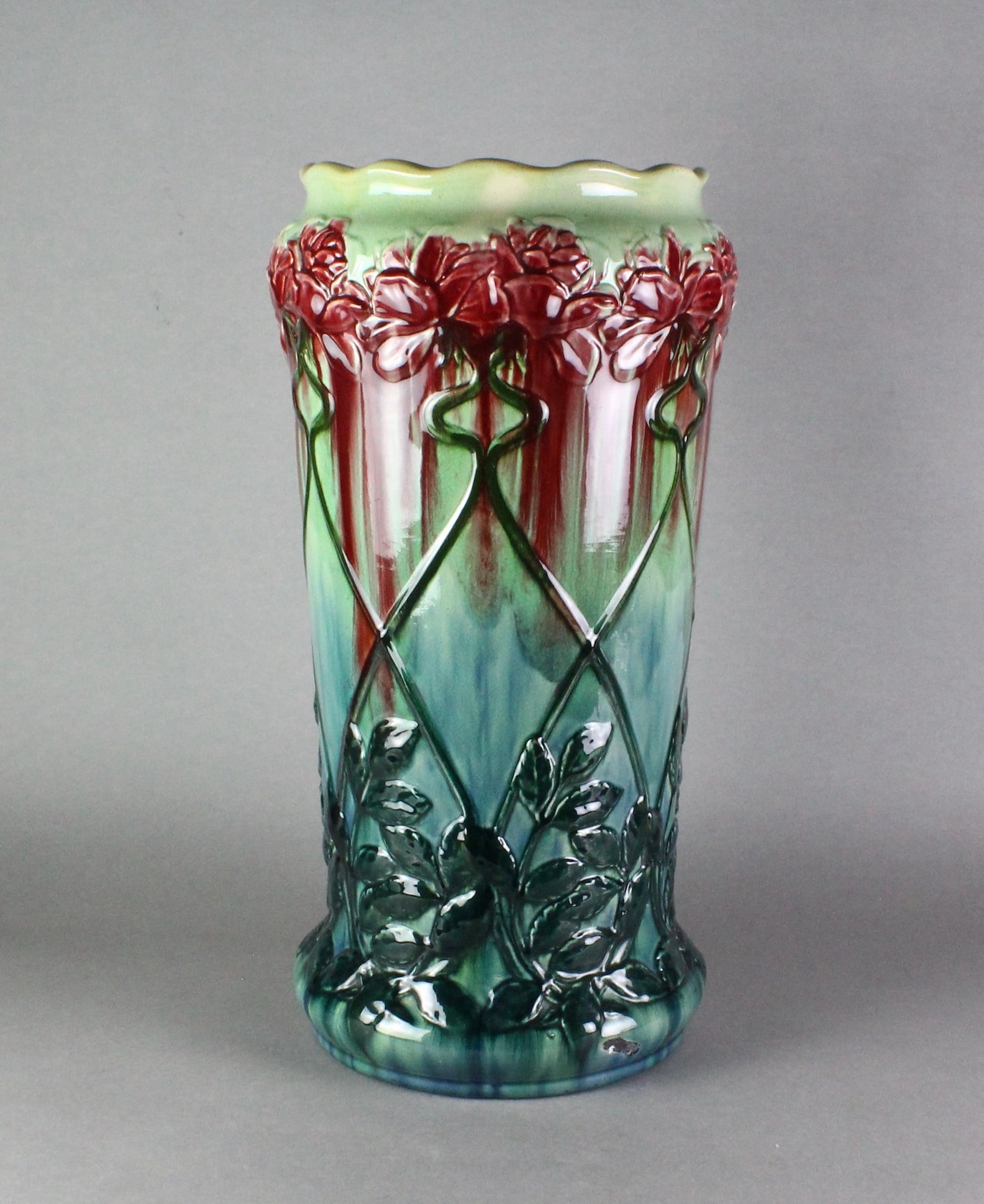 Roseville Pottery Early Majolica Umbrella Stand: Roseville Majolica Umbrella Stand. Early Nouveau pattern, 21 1/2 inches tall. Glaze scrape at base on one side.