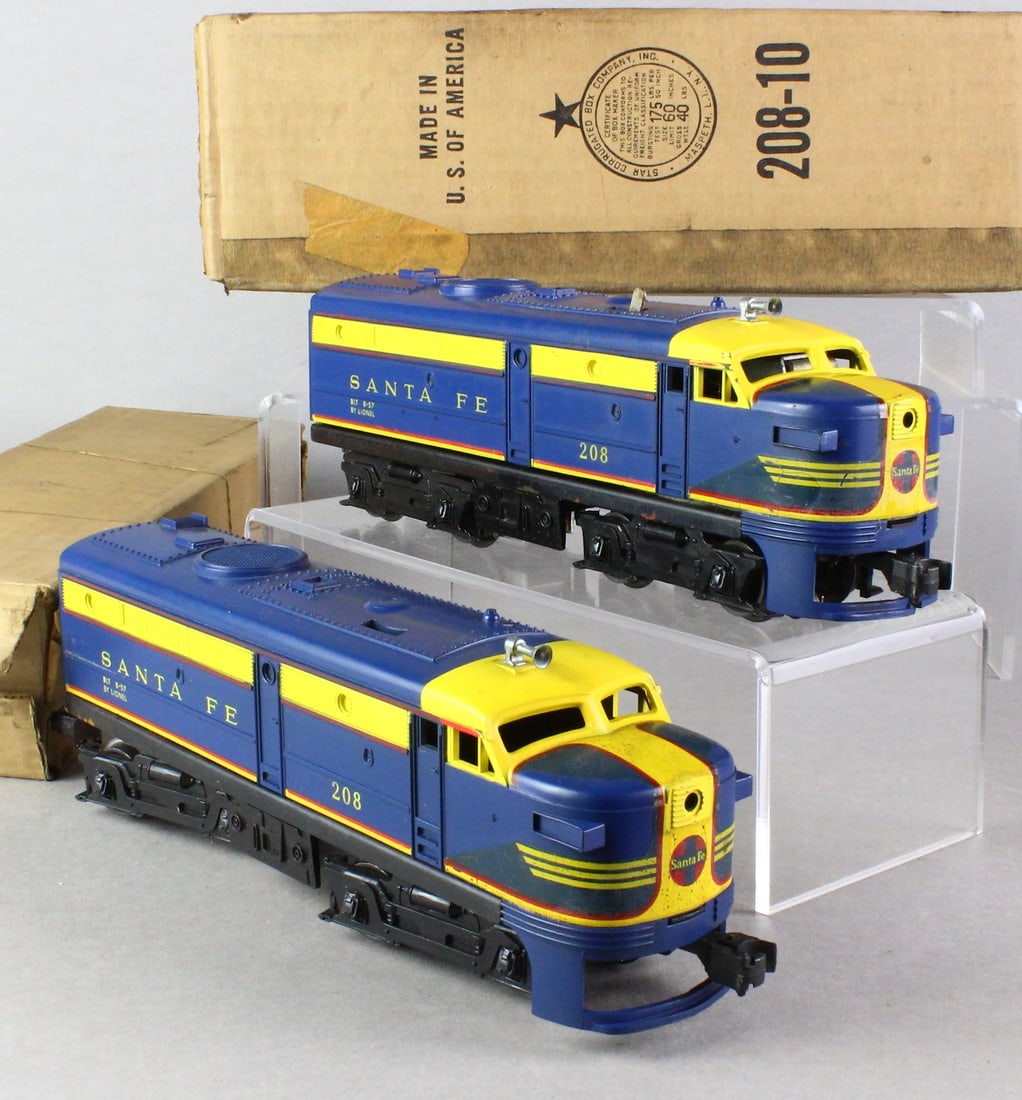Lionel 208 & 208T Santa Fe A-B Diesel Set In Boxes: Lionel 208 Santa Fe A-B Diesel Set In Boxes. Set appears never run, bright blue color, some storage surface rust on lower rear rail of both units.